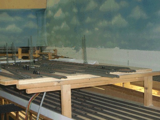 Teilweise herausgehobenes Gleismodul im linken Einfahrtsbereich des Modellbahnhofs mit sichtbaren Kabeln und darunterliegenden Gleisen