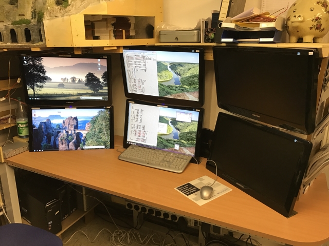 2016 neu eingerichteter Leitstand des MEC Gernsheim mit sechs Monitoren an einer Wand über einer großen Holzarbeitsplatte. Vier Bildschirme sind eingeschaltet, zwei stehen rechts übereinander.